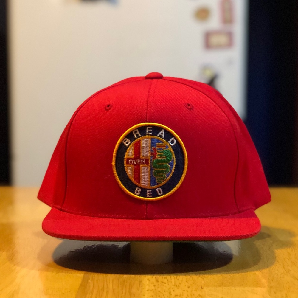 Bread over bed graphic SnapBack/Alpha Romeo emblem